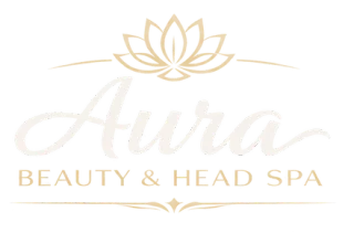Aura Beauty & Head Spa — a gold lotus above the studio's script wordmark